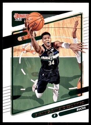 Basketball player in black Milwaukee Bucks uniform leaping for ball Panini Donruss Giannis Antetokounmpo