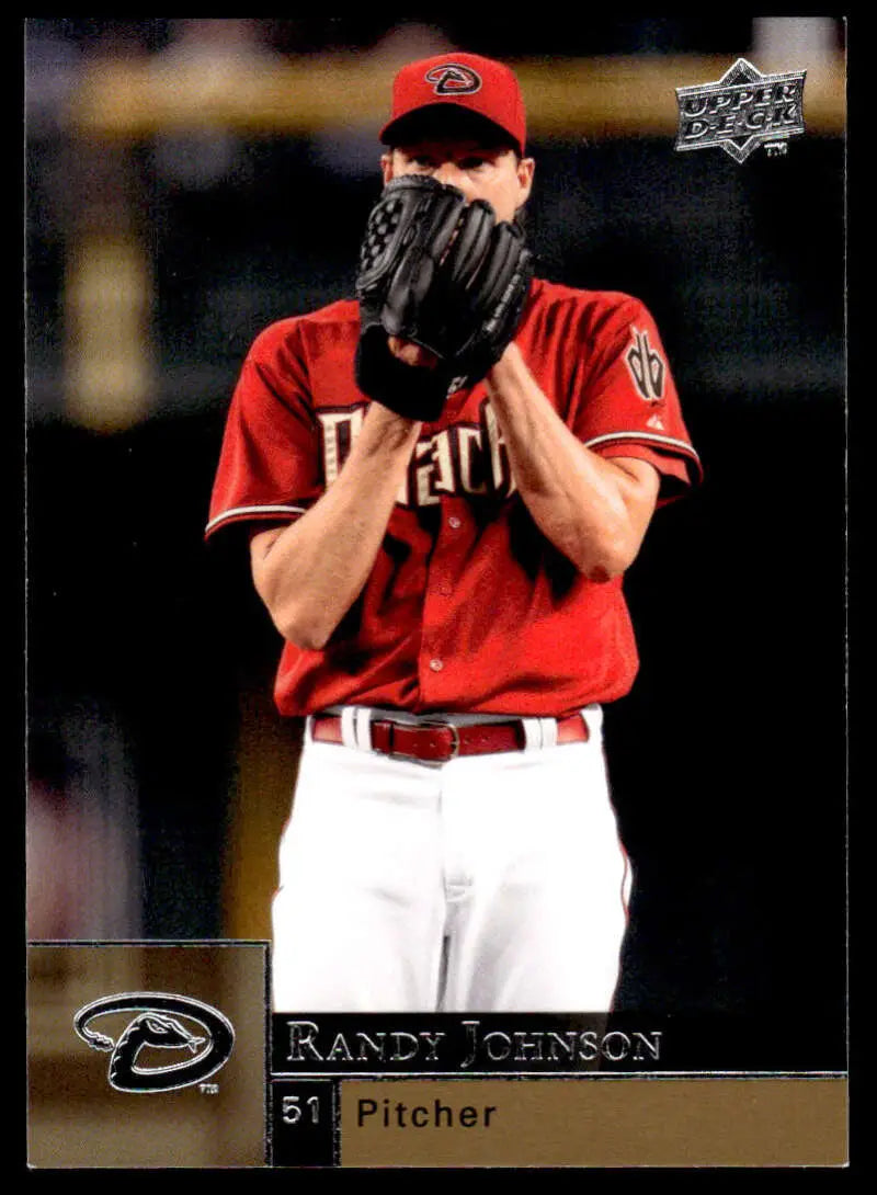 Randy Johnson in red Arizona Diamondbacks uniform covering face with glove