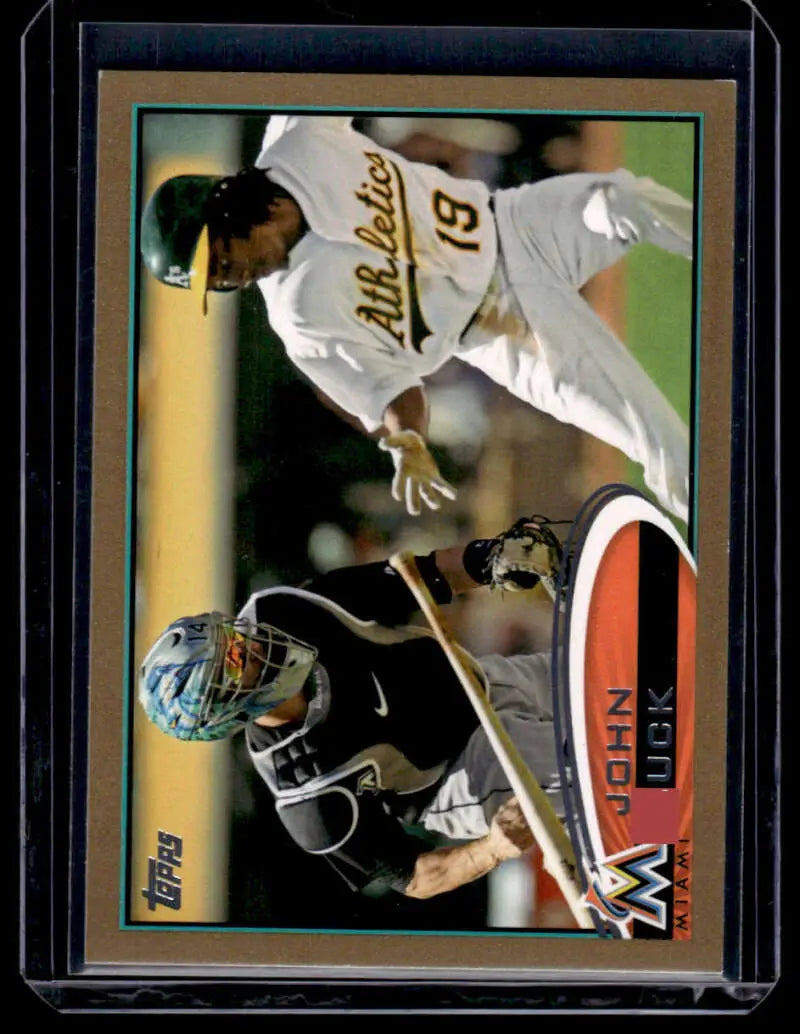 Baseball card featuring John Buck sliding into base for Miami Marlins against Oakland Athletics