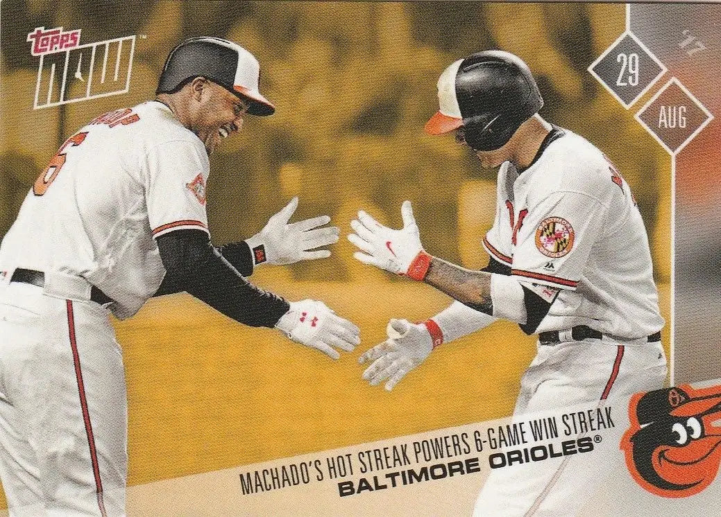 Baseball trading card of Manny Machado celebrating with Baltimore Orioles teammates