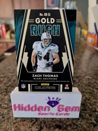 Miami Dolphins Zach Thomas relic patch card showcased in a Panini Gold series holder