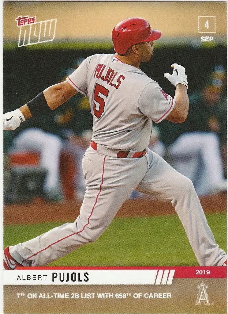 Baseball player in white uniform swinging bat, featuring Albert Pujols and Los Angeles Angels