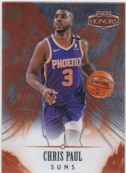 Chris Paul Phoenix Suns player holding a basketball in a team jersey