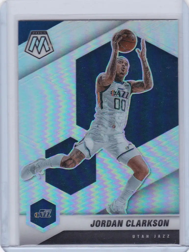 Jordan Clarkson Utah Jazz player in white uniform jumping with basketball on Panini Mosaic card