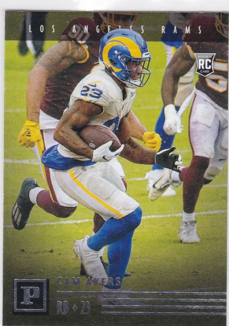 Football player in blue and yellow uniform running with ball for Panini Chronicles Akers RC Los