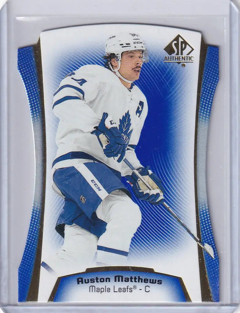 Hockey trading card of Auston Matthews in white jersey, featuring Authentic Diecut Blue DC17