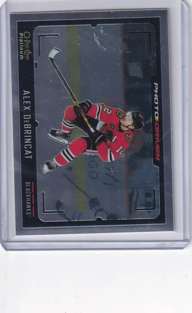 Hockey trading card of Alex DeBrincat making a diving shot in Upper Deck OPC Platinum