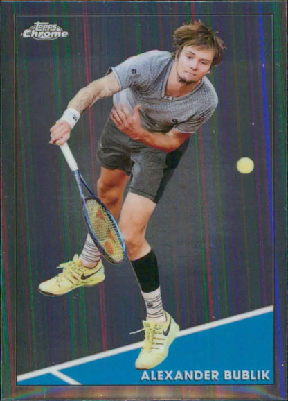 Tennis player serving in grey shirt and black shorts on Topps Chrome Alexander Bublik card