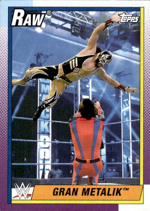 A WWE trading card of Gran Metalik performing an aerial maneuver in the ring