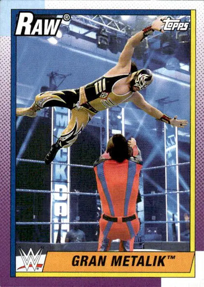 A WWE trading card of Gran Metalik performing an aerial maneuver in the ring