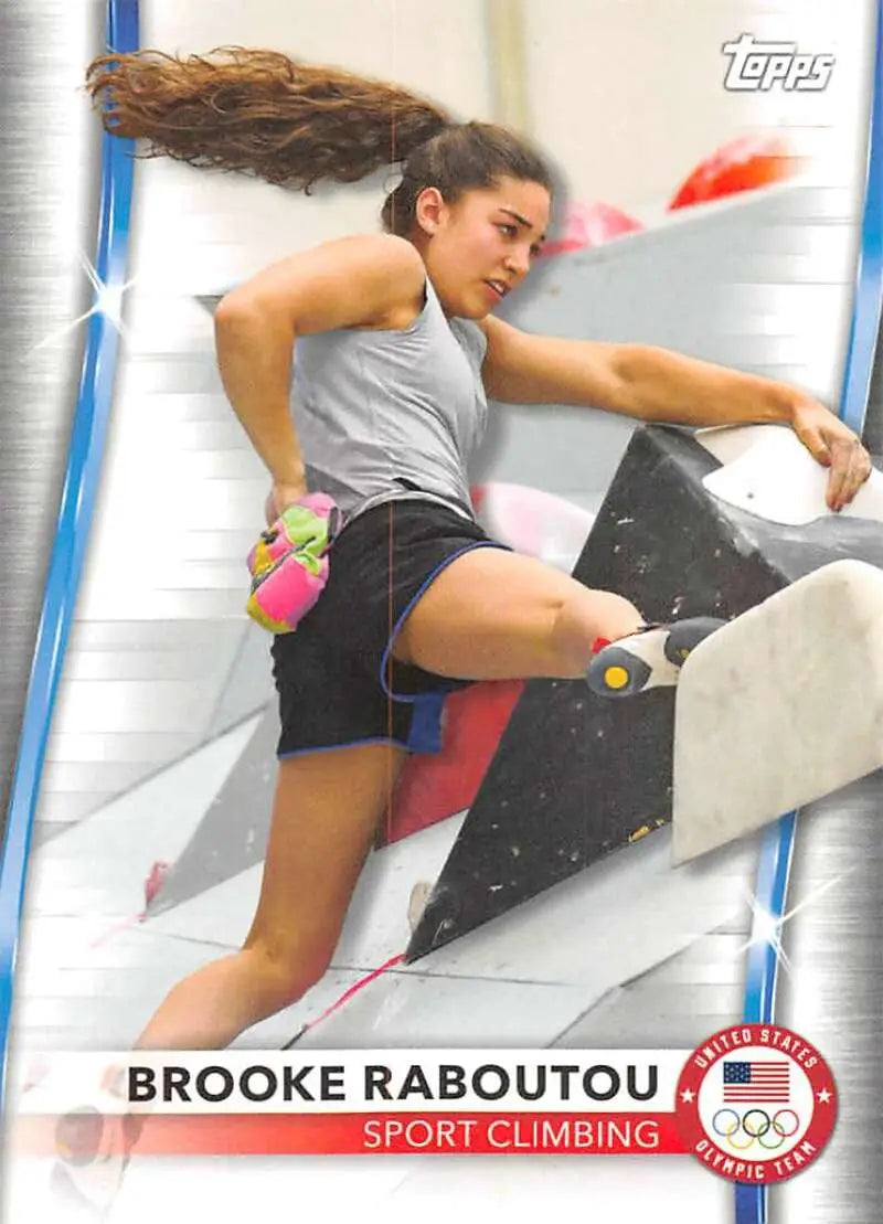 Sport climber Brooke Raboutou scales a wall in grey tank top and black shorts