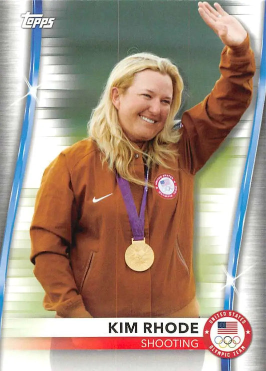 Olympic athlete Kim Rhode in brown Nike jacket waving with gold medal for Paralympics Team Hopefuls