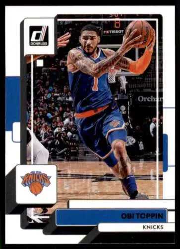 Obi Toppin driving to the basket in blue uniform on 2022-23 Donruss trading card