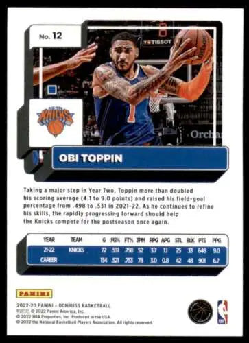 Basketball trading card of Obi Toppin in blue Knicks jersey making a pass, original gloss