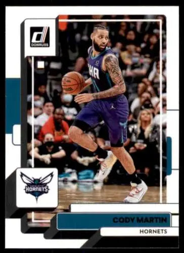 Basketball trading card of Cody Martin dribbling in purple for Charlotte Hornets