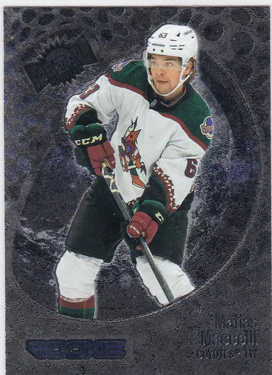 Hockey player in white and green jersey holding stick from Skybox Metal Universe Maccelli RC Coyotes