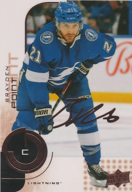 Hockey player in blue Tampa Bay Lightning jersey showcasing Upper Deck MVP 20th Anniversary card