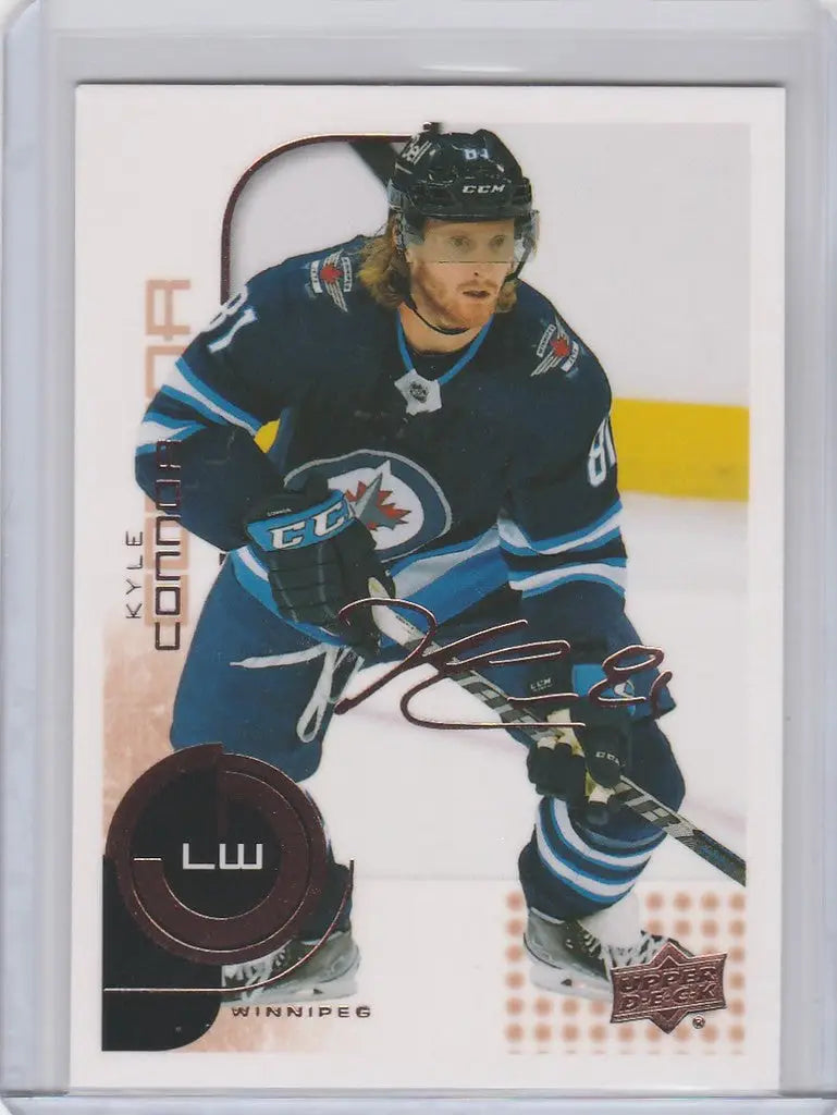 Hockey player in dark blue Winnipeg Jets jersey, Kyle Connor skating on ice, Upper Deck MVP