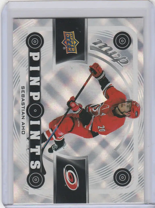 Hockey trading card of Sebastian Aho Carolina taking a slap shot in Upper Deck MVP Pinpoints