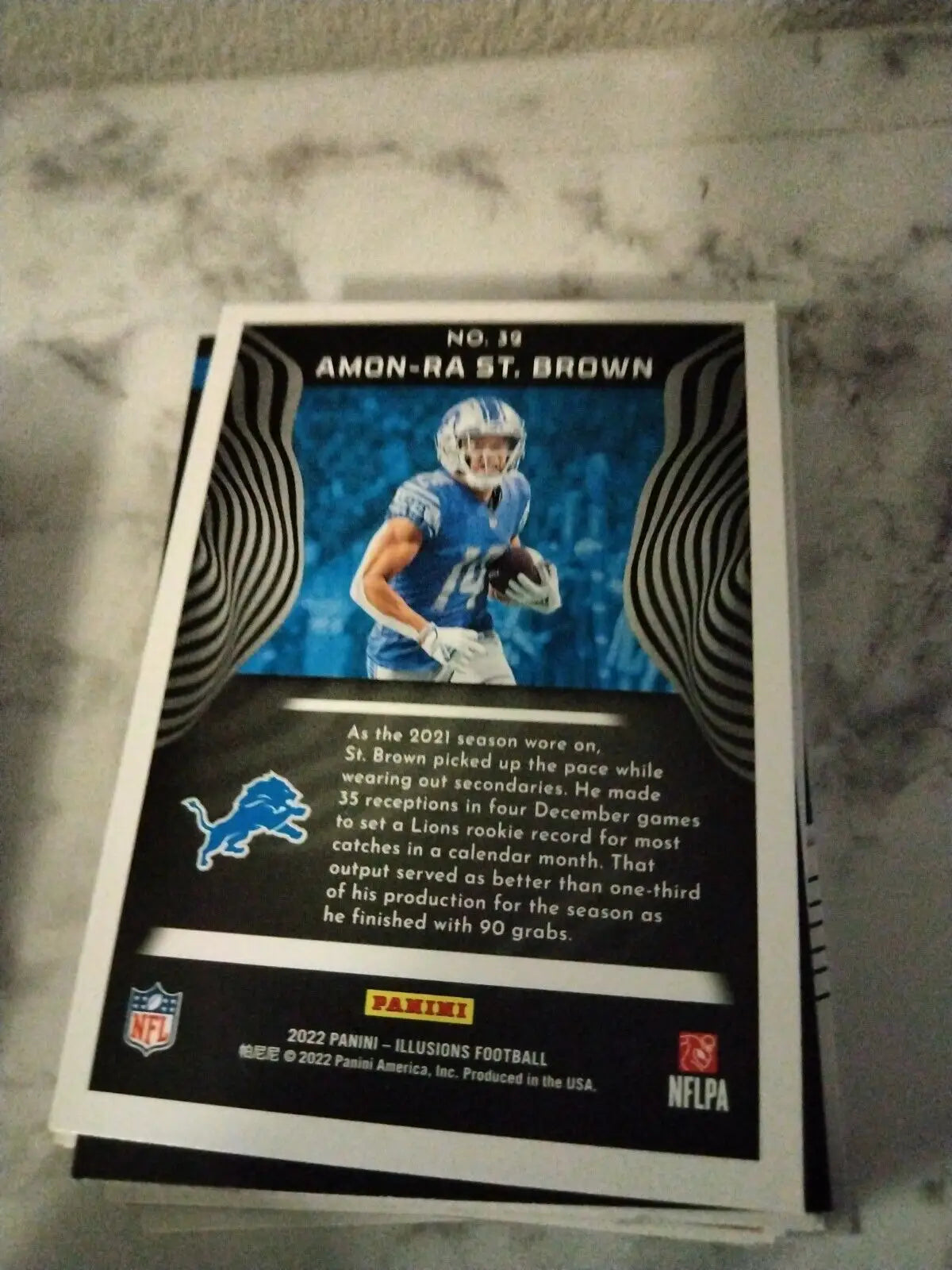 Amon-Ra St. Brown Base Card from 2022 Panini Illusions featuring Detroit Lions design