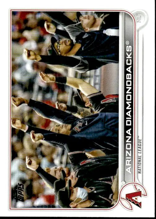 Baseball team members in dark uniforms celebrate in dugout for Arizona Diamondbacks