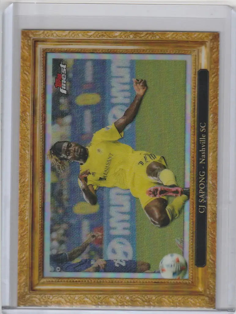 Framed Topps Finest MLS PITCHuresque card of CJ Sapong kicking a ball in yellow jersey