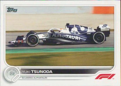 AlphaTauri Formula 1 racing car in navy blue and white livery featuring Yuki Tsunoda