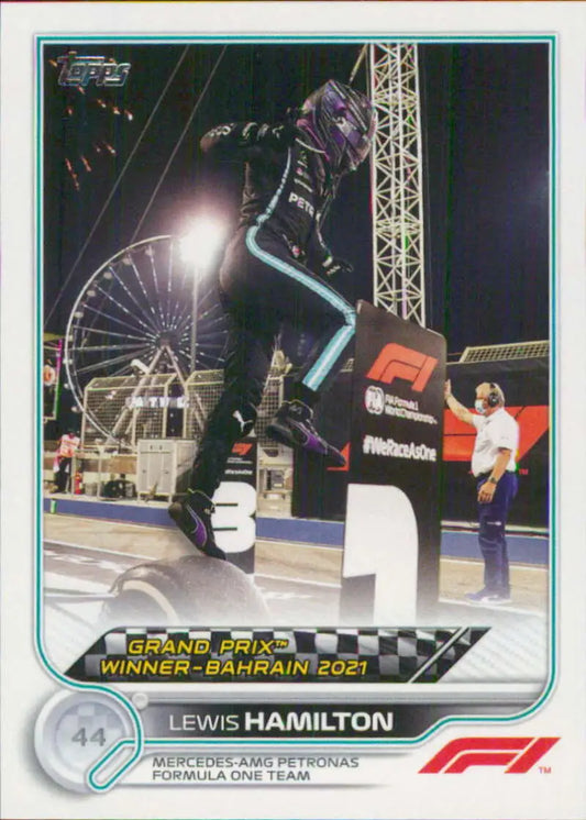 Lewis Hamilton celebrating victory on podium, Topps Formula 1 racing card 2022