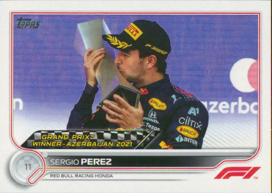 Sergio Perez celebrates victory with a trophy at the Azerbaijan Grand Prix on Topps Formula 1 card