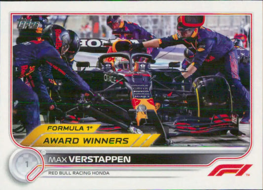 Max Verstappen in a Formula 1 race car serviced by pit crew for Topps Formula racing card