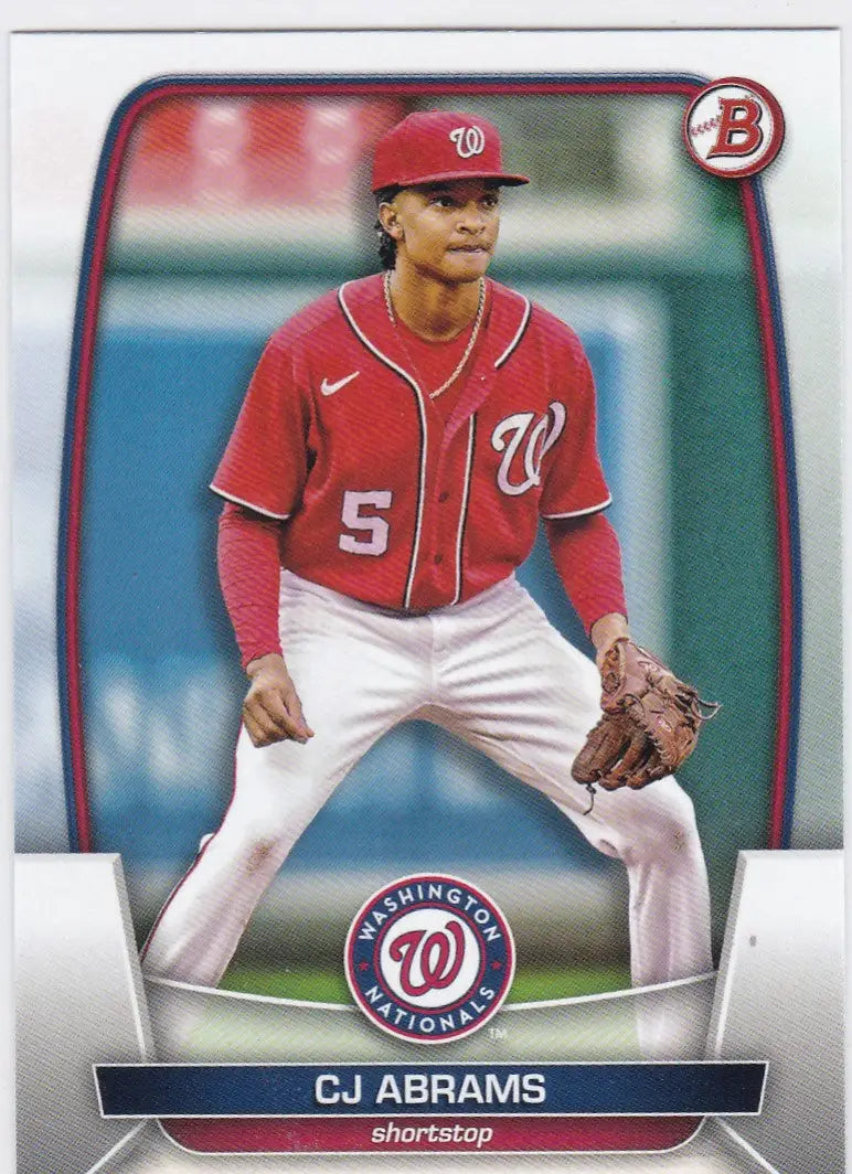 Baseball card of CJ Abrams Washington Nationals in fielding stance wearing red jersey