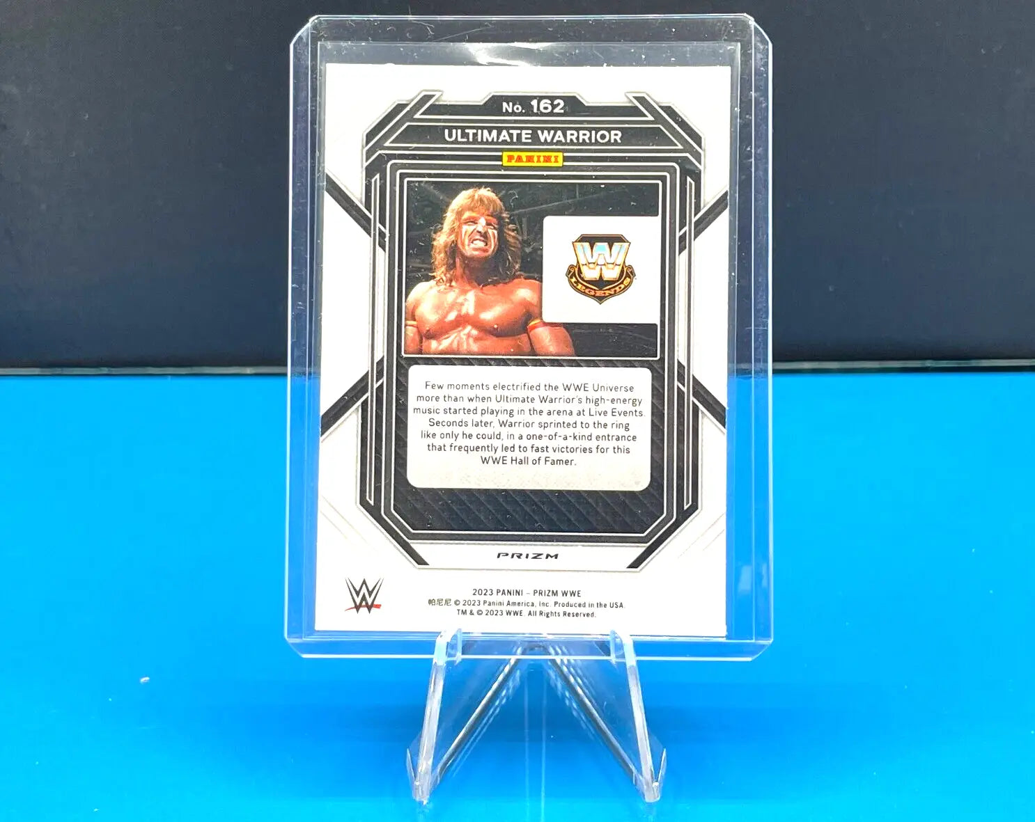 WWE trading card of Ultimate Warrior in a clear case with Silver Cracked Ice design