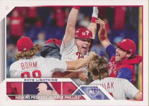 Baseball players in red and white uniforms celebrate in a joyous team huddle, Rhys Hoskins