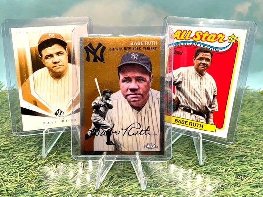 Three vintage Topps Chrome Platinum baseball cards on acrylic stands on grass