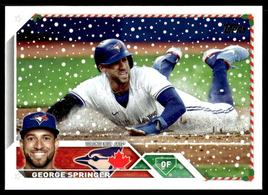 Baseball card of George Springer sliding into base for the Blue Jays in 2023 Topps Holiday