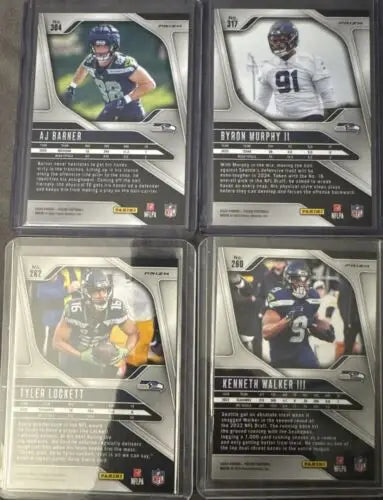 Four Panini Prizm trading cards featuring Red, White, & Blue Seahawks designs