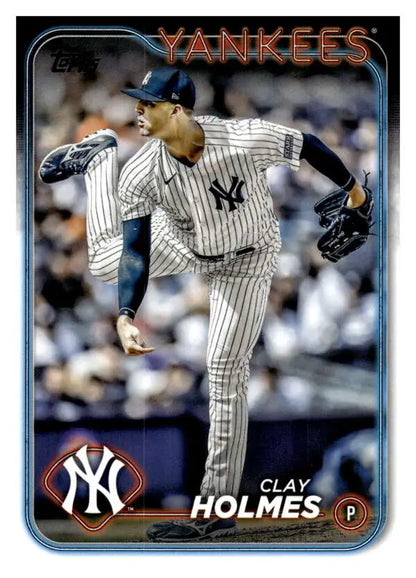 Clay Holmes delivering a pitch in pinstripe uniform on a New York Yankees baseball card