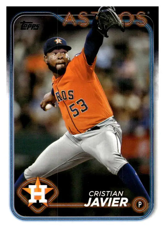 Cristian Javier delivering a pitch in an orange Houston Astros jersey baseball card