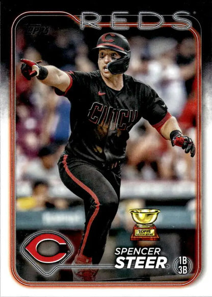 Spencer Steer in black Cincinnati Reds uniform pointing while batting on baseball card