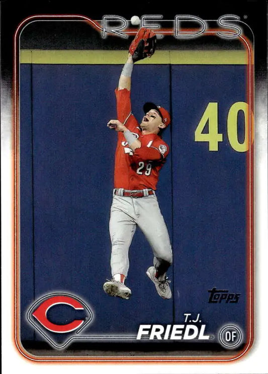 Cincinnati Reds baseball card of T.J. Friedl leaping to make a catch against a wall