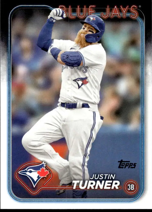 Justin Turner in a white home uniform batting for the Toronto Blue Jays