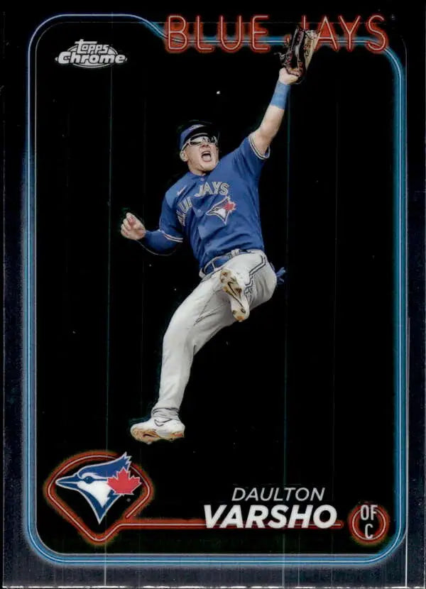 Daulton Varsho of the Toronto Blue Jays leaping to catch a baseball in action