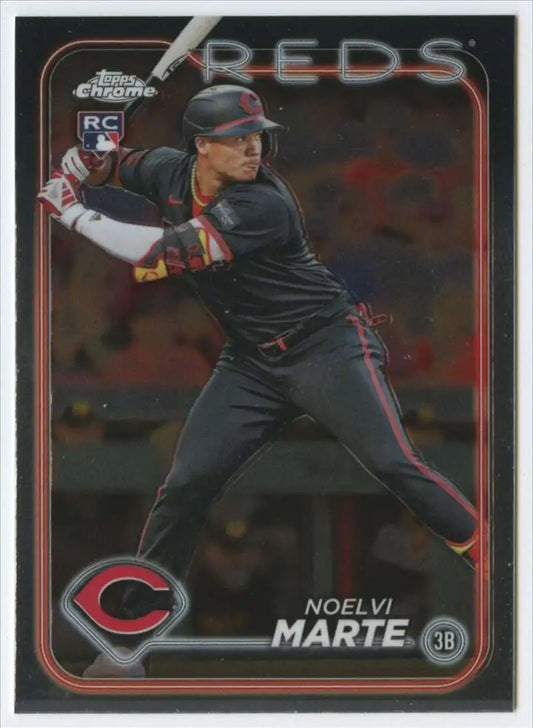 Noelvi Marte Cincinnati Reds Baseball Card in batting stance wearing a black uniform