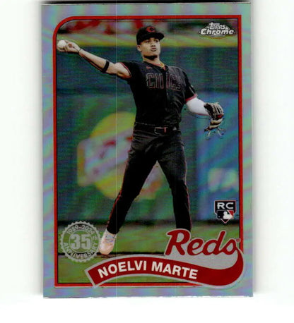 Noelvi Marte in black uniform throwing, 2024 Topps Chrome Cincinnati Reds Baseball Card