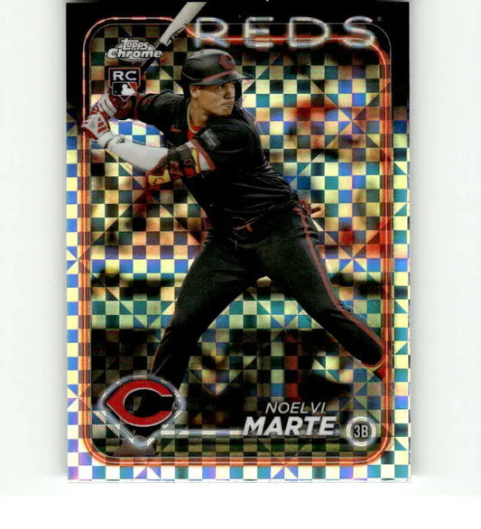 Noelvi Marte at bat in black uniform on 2024 Topps Chrome X-Fractor Cincinnati Reds Card