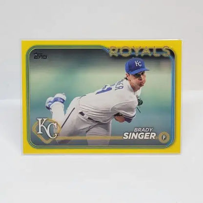 Baseball card of Brady Singer in mid-throwing motion from Topps Series yellow border design