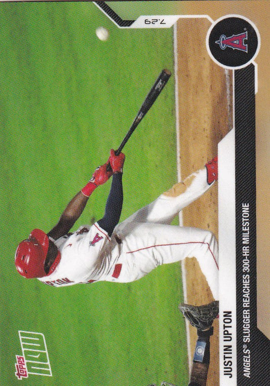 Baseball player Justin Upton in white uniform swinging bat for Los Angeles Angels