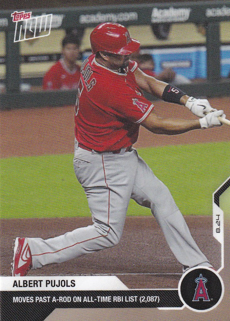 Baseball player Albert Pujols in red uniform swinging bat for Los Angeles Angels