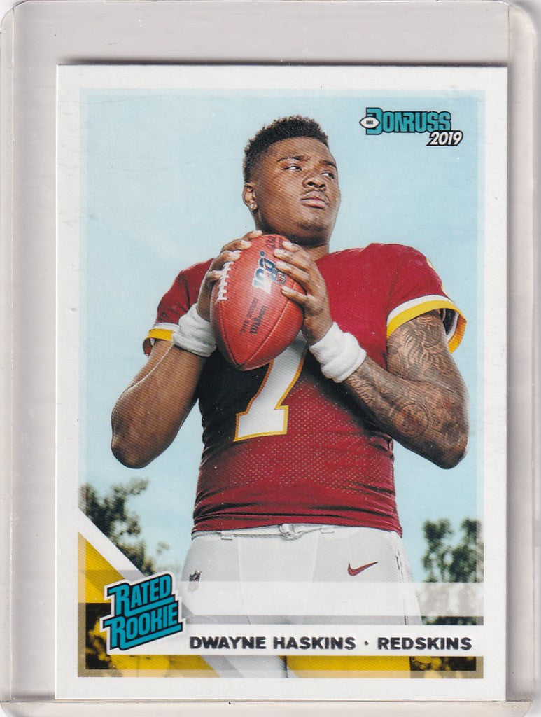 Dwayne Haskins Washington Commanders football trading card holding a football