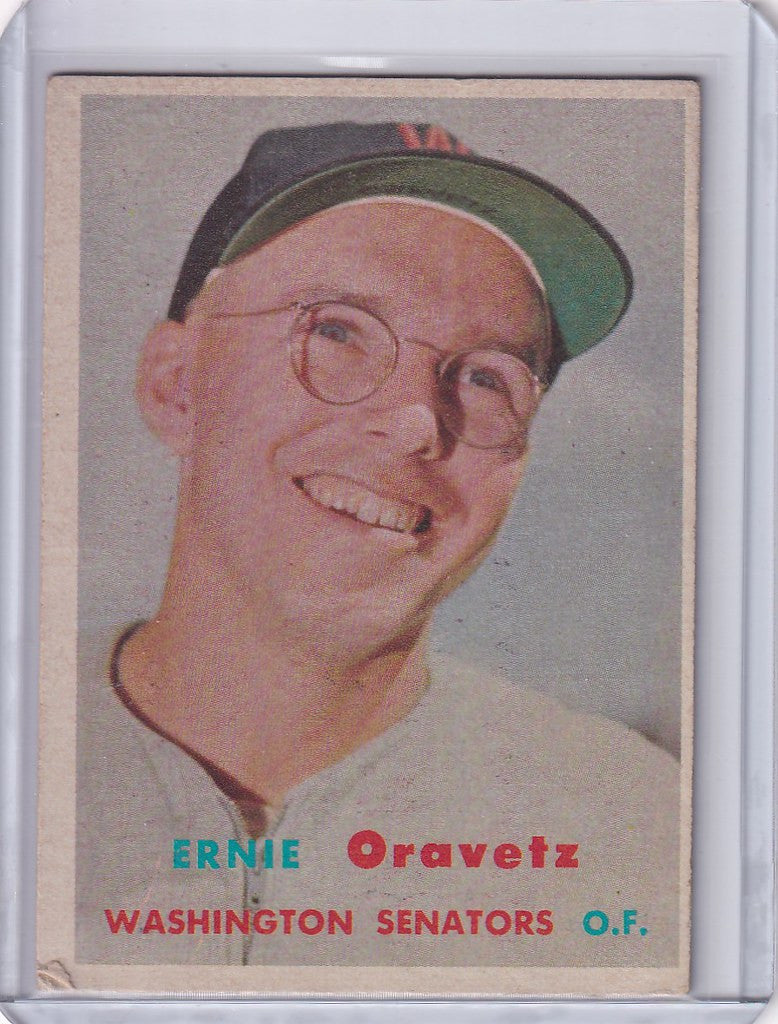 Smiling Ernie Oravetz in cap and glasses on 1957 Topps Baseball card for Washington Senators